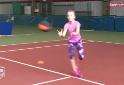 Young tennis hopeful showing perfect form in training